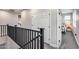 Upstairs hallway with neutral walls with view into a bedroom at 19443 W Valle Vista Way, Litchfield Park, AZ 85340