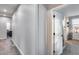 Bright hallway featuring neutral walls, soft carpeting, and white doors leading to various rooms at 19443 W Valle Vista Way, Litchfield Park, AZ 85340