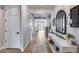 Inviting hallway featuring wood floors, neutral walls, and stylish decor including a console table and rug at 19443 W Valle Vista Way, Litchfield Park, AZ 85340