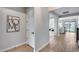 Bright hallway showcasing wood floors, neutral walls, and a glimpse into the living room and backyard at 19443 W Valle Vista Way, Litchfield Park, AZ 85340