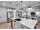 Bright, open kitchen with a spacious island, stainless steel appliances, and seamless access to the living area at 19443 W Valle Vista Way, Litchfield Park, AZ 85340