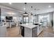 Modern kitchen with island seating flows into a cozy living space, creating an inviting atmosphere at 19443 W Valle Vista Way, Litchfield Park, AZ 85340