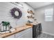 Charming laundry room with butcher block countertops, shiplap walls, and modern appliances at 19443 W Valle Vista Way, Litchfield Park, AZ 85340