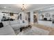 Open-concept living room with modern decor, seamlessly connecting to the kitchen and office spaces at 19443 W Valle Vista Way, Litchfield Park, AZ 85340