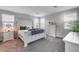 Inviting main bedroom with a stylish white bed frame, plush carpeting, and abundant natural light at 19443 W Valle Vista Way, Litchfield Park, AZ 85340