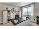 Bright home office featuring a black desk, stylish storage, and natural light from the window at 19443 W Valle Vista Way, Litchfield Park, AZ 85340