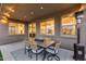 Covered outdoor patio with a table, chairs, heater, and recessed lighting offers a cozy place to relax at 19443 W Valle Vista Way, Litchfield Park, AZ 85340