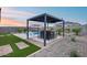 Beautiful in-ground pool with built-in seating area, outdoor kitchen and lounge chairs perfect for entertaining at 19443 W Valle Vista Way, Litchfield Park, AZ 85340