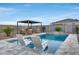 Relaxing poolside featuring lounge chairs and seating area, creating a private backyard retreat at 19443 W Valle Vista Way, Litchfield Park, AZ 85340