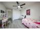 Clean bedroom with a desk and strawberry-themed bedspread, complemented by wood-look tile flooring at 19622 N 66Th Ln, Glendale, AZ 85308