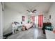 Cheerful bedroom with cute decor, featuring a comfortable bed, study desk, and a ceiling fan at 19622 N 66Th Ln, Glendale, AZ 85308