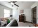 Well-lit bedroom featuring a ceiling fan, closet, and a window for ample natural light and comfort at 19622 N 66Th Ln, Glendale, AZ 85308