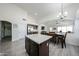 Open-concept kitchen featuring a large island, dining area, and seamless flow into the living space at 19622 N 66Th Ln, Glendale, AZ 85308