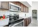 Close up shot of the stovetop, microwave, and backsplash in the kitchen at 19622 N 66Th Ln, Glendale, AZ 85308