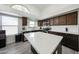 Modern kitchen featuring white countertops, stainless steel appliances, and sleek dark cabinetry at 19622 N 66Th Ln, Glendale, AZ 85308