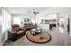 Inviting living room with modern archway to the kitchen, featuring plush seating and a ceiling fan at 19622 N 66Th Ln, Glendale, AZ 85308