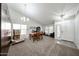 Bright living room featuring neutral carpet, vaulted ceiling, and abundant natural light at 19622 N 66Th Ln, Glendale, AZ 85308