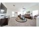 Bright living room features vaulted ceiling, neutral paint and flooring, and comfortable reclining furniture at 19622 N 66Th Ln, Glendale, AZ 85308