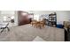 Spacious living room featuring neutral carpet, built-in shelving, and ample natural light at 19622 N 66Th Ln, Glendale, AZ 85308