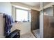 Modern shower with a window, bench, gray tile, and a mosaic tile floor at 19622 N 66Th Ln, Glendale, AZ 85308