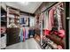 Spacious walk-in closet boasts custom wood cabinetry with ample storage, shelving, and LED lighting at 19622 N 66Th Ln, Glendale, AZ 85308