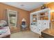 Comfortable guest bedroom featuring custom bookcase, neutral walls and carpet, and great natural light at 21816 E Puesta Del Sol --, Queen Creek, AZ 85142