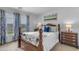 This bedroom features a wooden bed frame, plush bedding, and bright natural light from the window at 21816 E Puesta Del Sol --, Queen Creek, AZ 85142