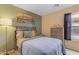 This bedroom features neutral walls, comfortable bedding, and bright natural light from the window at 21816 E Puesta Del Sol --, Queen Creek, AZ 85142