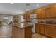 Spacious kitchen featuring wood cabinets, stone countertops, stainless appliances, and a breakfast bar at 21816 E Puesta Del Sol --, Queen Creek, AZ 85142