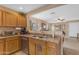 View of the kitchen with stainless steel appliances, wood cabinetry, and a view into the dining room at 21816 E Puesta Del Sol --, Queen Creek, AZ 85142