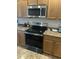 The kitchen features stainless steel appliances and wooden cabinets at 21816 E Puesta Del Sol --, Queen Creek, AZ 85142