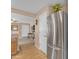 Close-up of stainless steel refrigerator with kitchen area and view into the living area at 21816 E Puesta Del Sol --, Queen Creek, AZ 85142