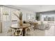 Inviting open-concept living space with dining area, stylish furniture, and natural light, perfect for gatherings at 25461 W Graham Trl, Buckeye, AZ 85326
