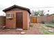 A backyard shed with an air conditioner and a chair next to the backyard at 2619 W Lamar Rd, Phoenix, AZ 85017