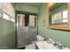 Standard bathroom featuring a vanity sink, toilet, and walk-in shower with a glass door at 2619 W Lamar Rd, Phoenix, AZ 85017