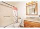 Well-maintained bathroom with a shower-tub combo and a marble top vanity at 2619 W Lamar Rd, Phoenix, AZ 85017
