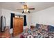Comfortable bedroom with stylish bedding, wooden furniture, and a modern ceiling fan at 2619 W Lamar Rd, Phoenix, AZ 85017