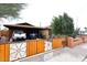 Charming brick home with a custom wooden fence and covered parking, showcasing Southwestern curb appeal at 2619 W Lamar Rd, Phoenix, AZ 85017