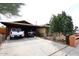 Charming brick home with covered parking, set in a desert landscape with mature trees at 2619 W Lamar Rd, Phoenix, AZ 85017