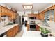 Bright kitchen with oak cabinets, tile countertops, and stainless steel appliances at 2619 W Lamar Rd, Phoenix, AZ 85017