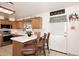 Bright kitchen with oak cabinets, tile countertops, and barstool seating at 2619 W Lamar Rd, Phoenix, AZ 85017