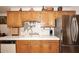 Traditional kitchen with tile countertops, wooden cabinets, stainless steel refrigerator, and modern faucet at 2619 W Lamar Rd, Phoenix, AZ 85017