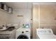 A cluttered laundry room area, equipped with an oven, washing machine and dryer at 2619 W Lamar Rd, Phoenix, AZ 85017