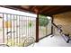Covered patio features rod iron fencing with brick posts, bike and workout equipment at 2619 W Lamar Rd, Phoenix, AZ 85017