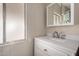 Bathroom showcasing vanity with white cabinetry, countertop, mirror, and brushed nickel fixtures at 2650 W Union Hills Dr # 350, Phoenix, AZ 85027