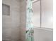 Bathroom with tiled shower featuring decorative niche and window providing natural light at 2650 W Union Hills Dr # 350, Phoenix, AZ 85027