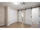 Bedroom featuring multiple doors and closets, with modern barn doors providing private entry to bathroom at 2650 W Union Hills Dr # 350, Phoenix, AZ 85027