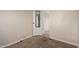 Cozy bedroom with neutral carpet, paneled walls, and open door at 2650 W Union Hills Dr # 350, Phoenix, AZ 85027