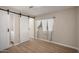 Bedroom features sliding barn door and window with light blue curtains, showcasing bright space at 2650 W Union Hills Dr # 350, Phoenix, AZ 85027