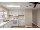 Bright kitchen with appliances, white cabinets, countertops, and a double sink at 2650 W Union Hills Dr # 350, Phoenix, AZ 85027